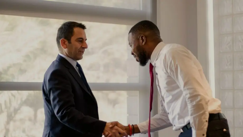 Two professionals meeting for the first time in a modern office