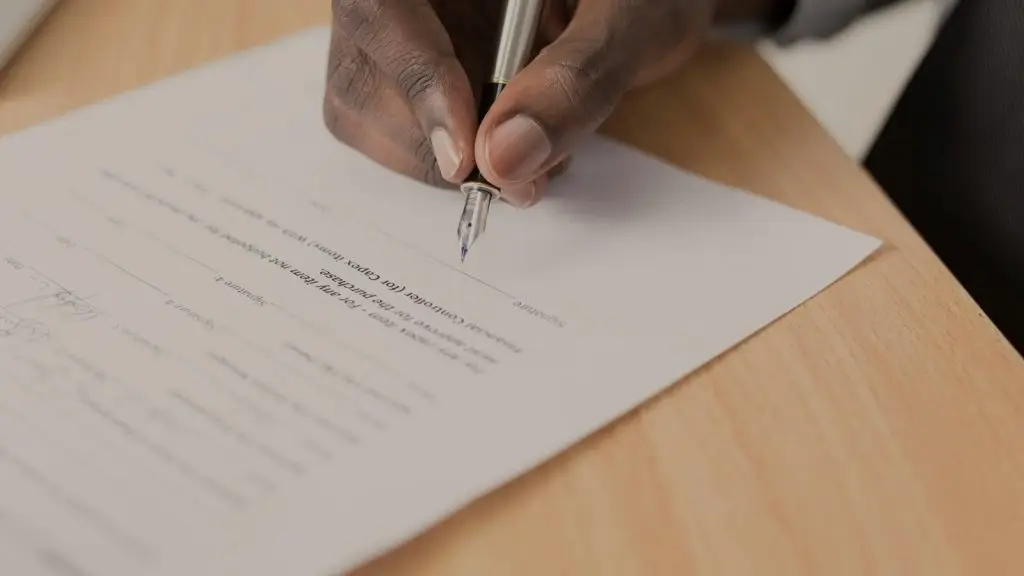 A signed agreement and pen on a clean desk