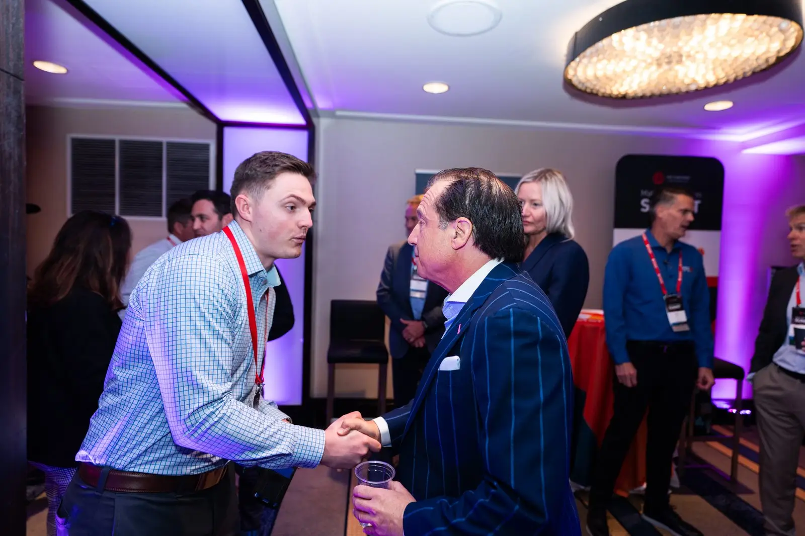 Summit attendees greeting each other at a reception