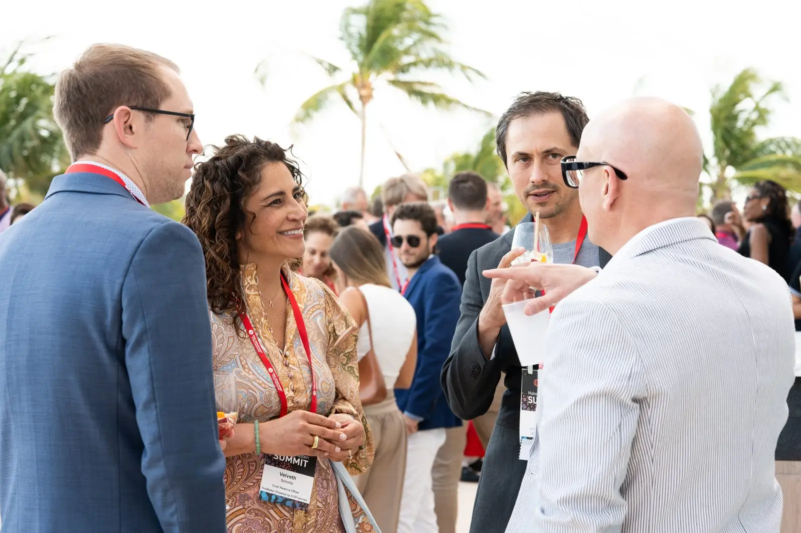 Summit attendees in conversation on the terrace