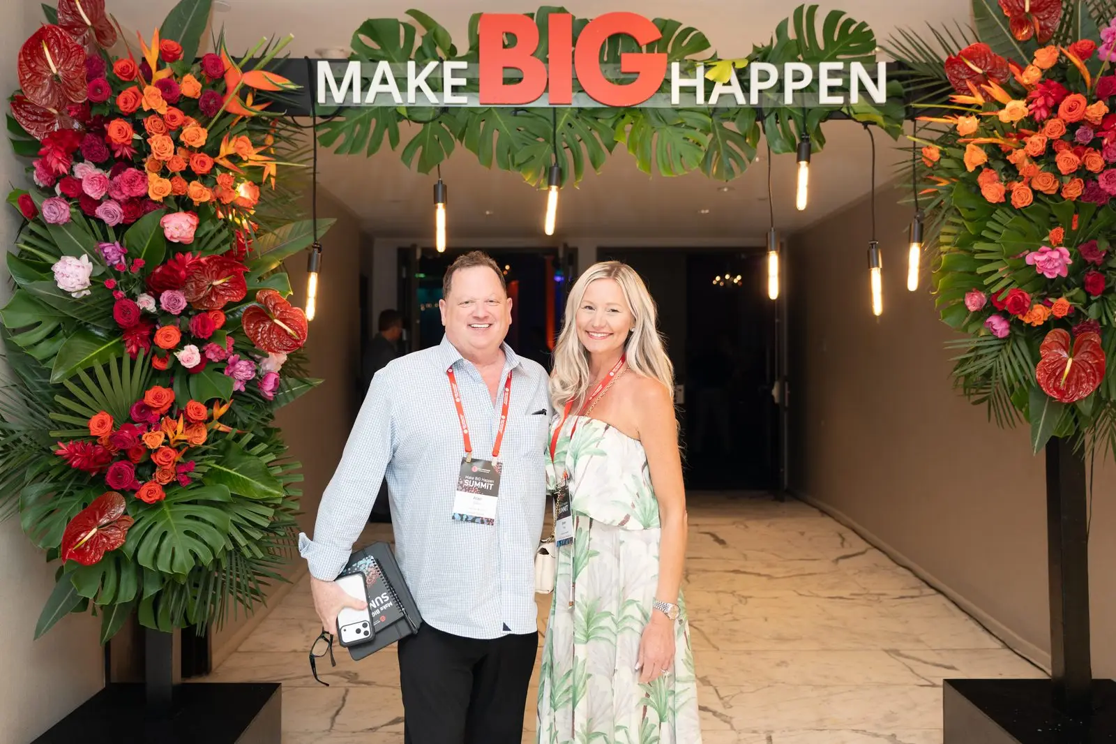Attendees arriving beneath the Make BIG Happen entrance