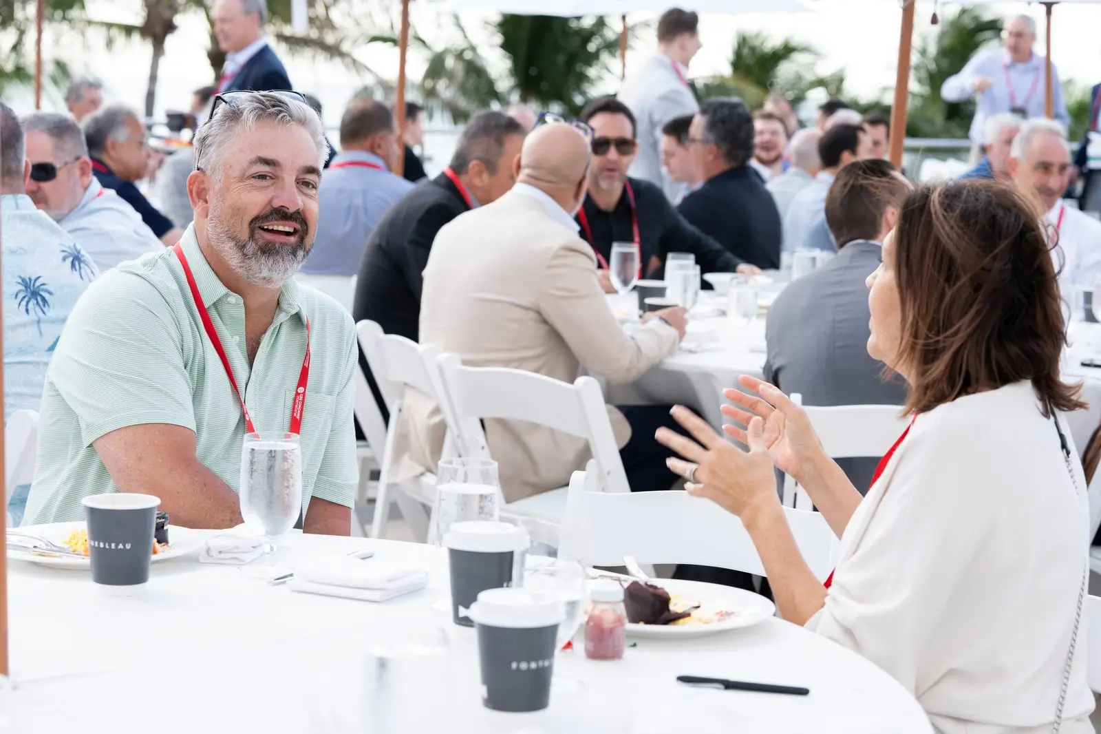 CEOs in conversation over an outdoor Summit meal